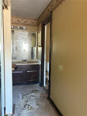 a bathroom with a glass door shower and a sink