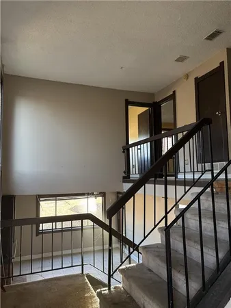 a view of staircase with lots of white walls