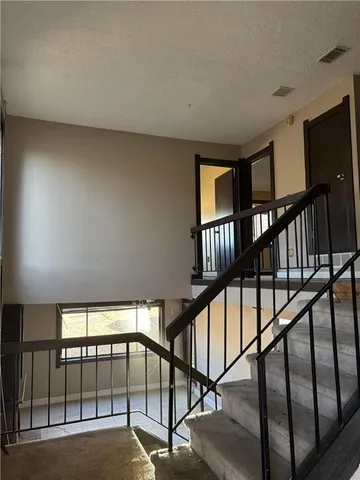 a view of staircase with lots of white walls