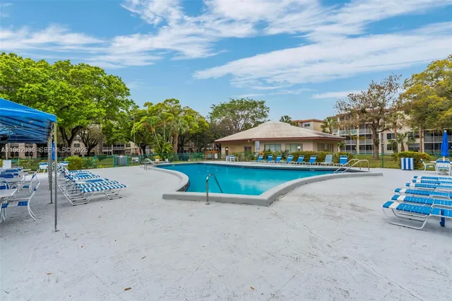 a view of street with houses and trees in the background