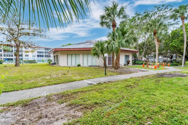 a front view of a building with a garden
