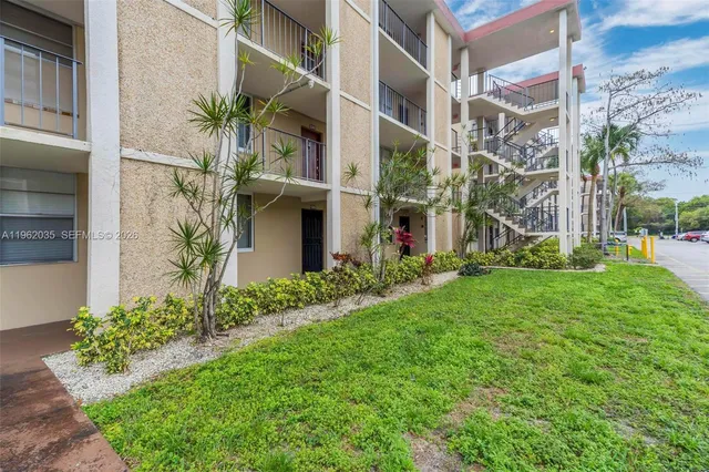 a front view of building with garden