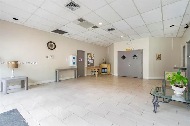 a view of a white building with a view of a city from a terrace