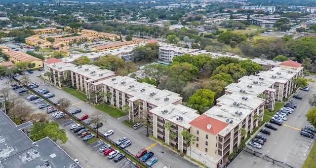 an aerial view of a house with a yard and garden