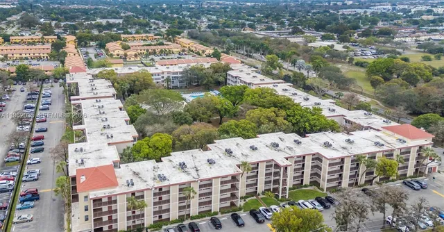 an aerial view of a house with a yard basket ball court