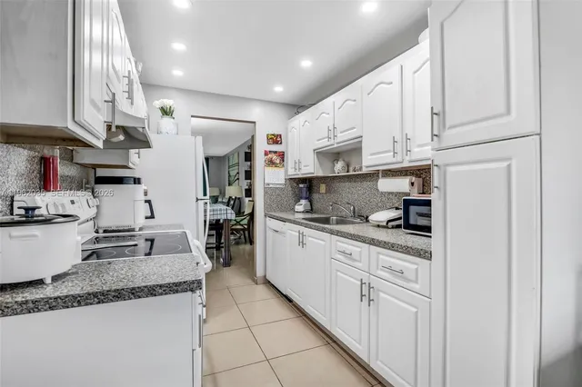 a kitchen with stainless steel appliances granite countertop a sink and cabinets