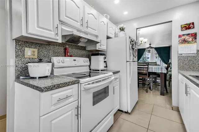 a kitchen with stainless steel appliances granite countertop a stove and a refrigerator