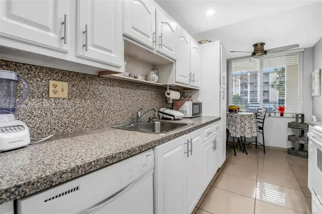 a kitchen with sink cabinets and window