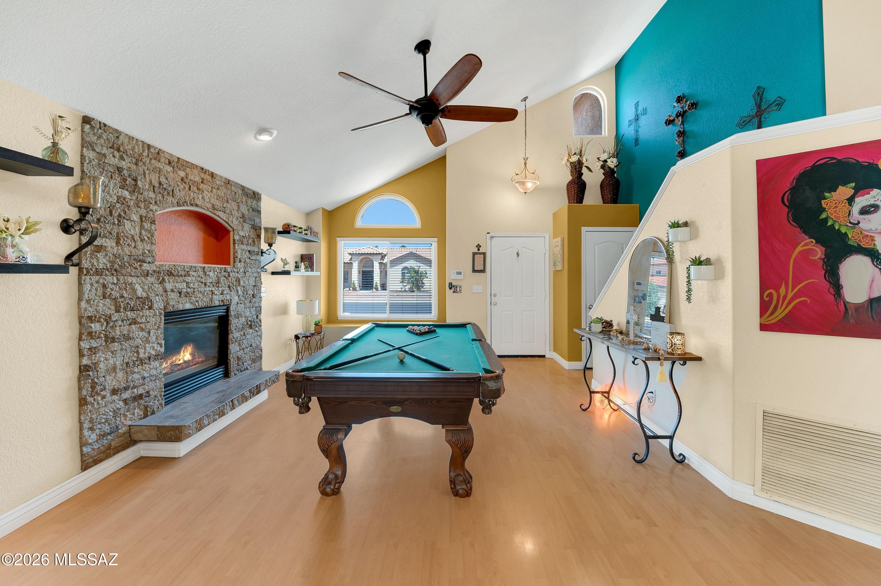 7159 West Maple Ridge Drive Tucson, AZ 85743 - Photo 5 of 42 a living room with furniture and a fireplace