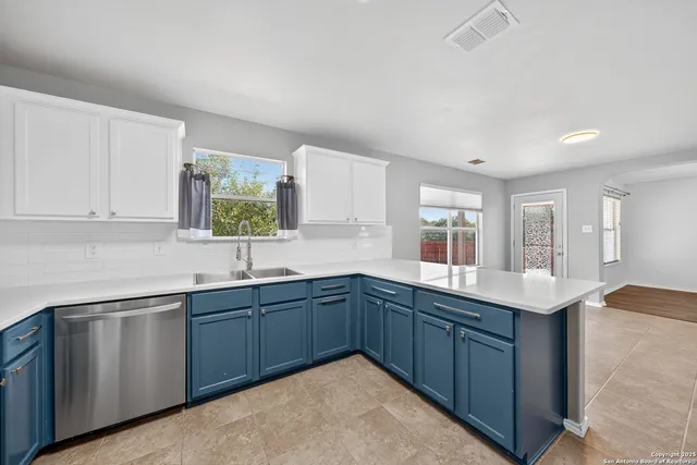 a kitchen with sink and view living room