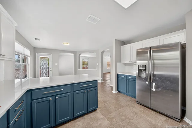 a kitchen with stainless steel appliances granite countertop a refrigerator and a sink
