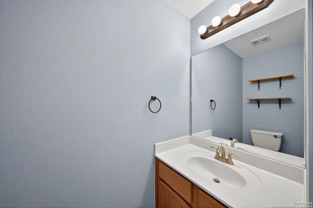 a bathroom with a sink vanity and a mirror