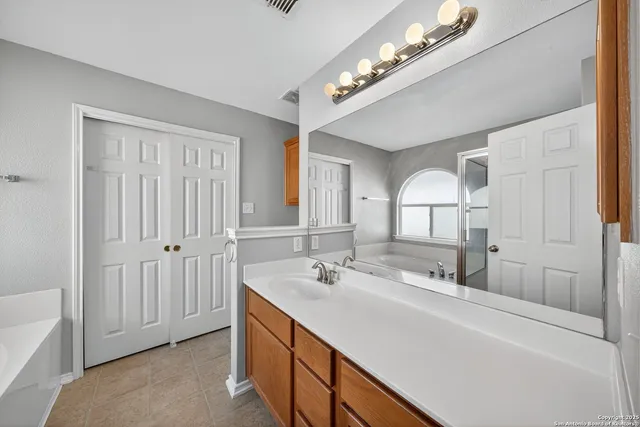 a bathroom with a double vanity sink and a mirror