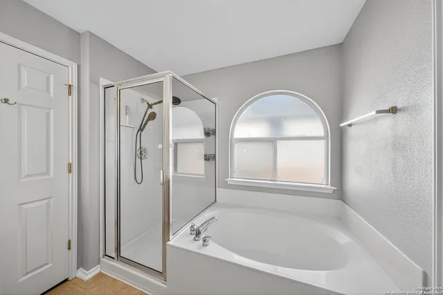 a bathroom with a tub shower and sink