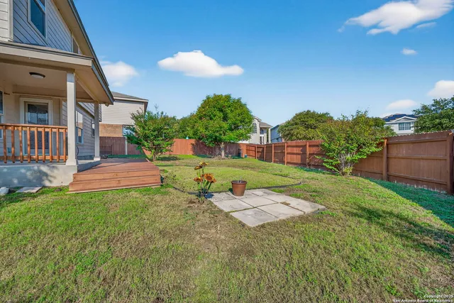 a backyard of a house with table and chairs