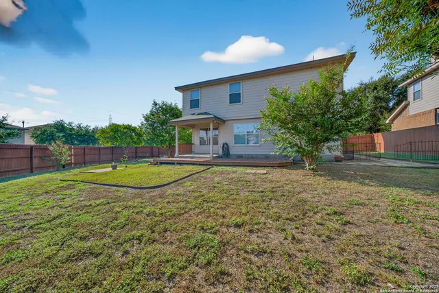 a view of a house with backyard and sitting area