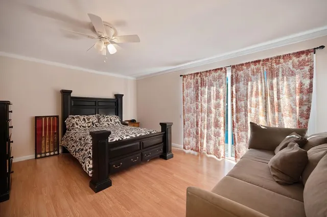 a bedroom with furniture and wooden floor