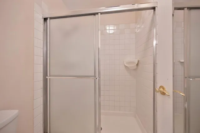 a bathroom with a glass shower door