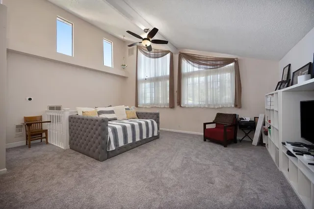 a bedroom with furniture and a flat screen tv