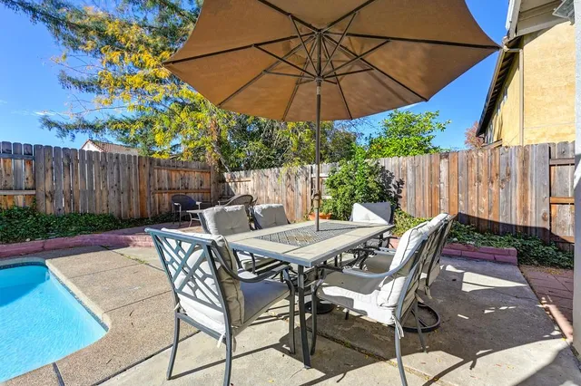 a patio with a patio table and chairs