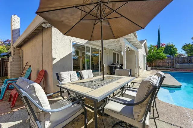 a view of an outdoor space with furniture and umbrella