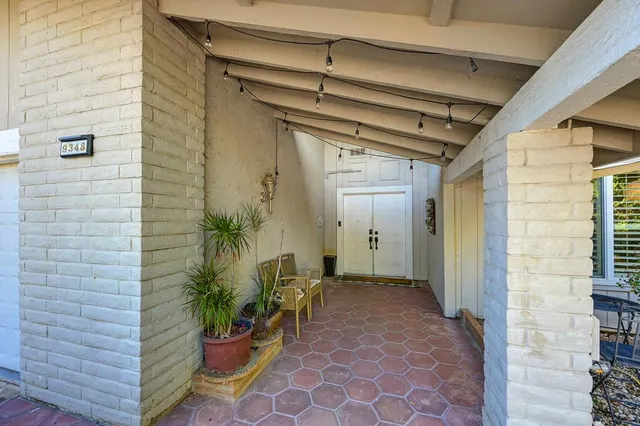 a view of a porch with potted plants