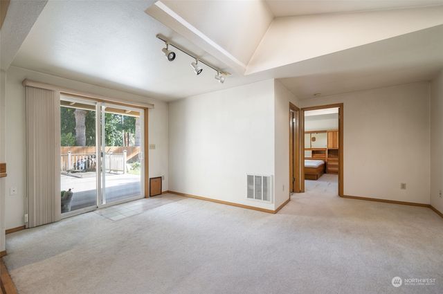 an empty room with sliding glass door and shower