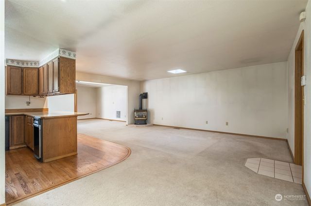 a view of kitchen with granite countertop cabinets and refrigerator