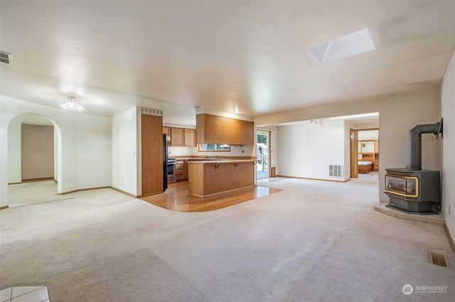 a view of a kitchen with a sink and a refrigerator