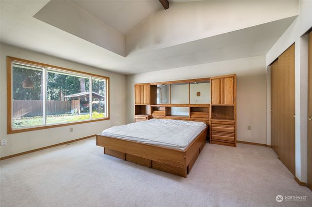 a spacious bedroom with a bed and a large window