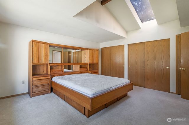 a bed sitting in a room next to a window