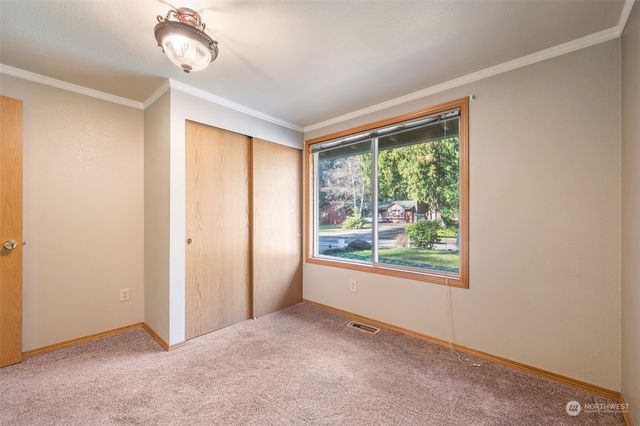 an empty room with windows and outdoor view