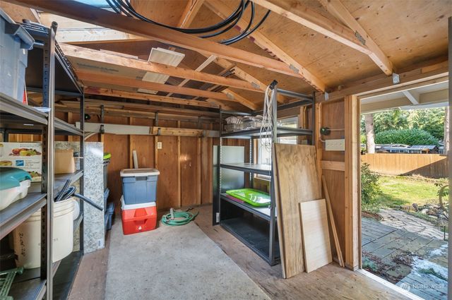 a view of a room with wooden floor and iron stairs