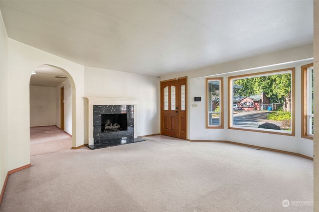 an empty room with furniture and a fireplace