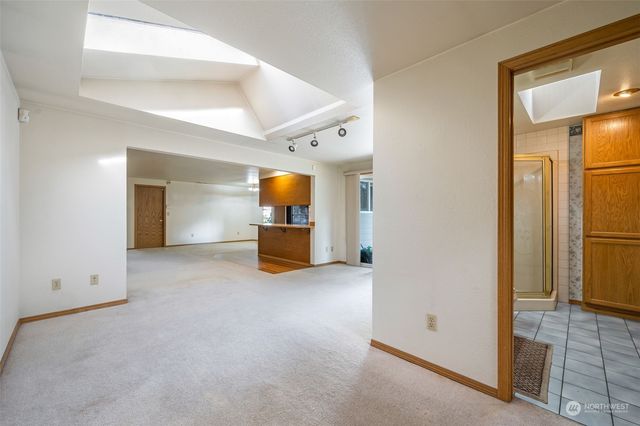 a view of an empty room with a kitchen