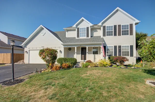 a front view of house with yard and green space