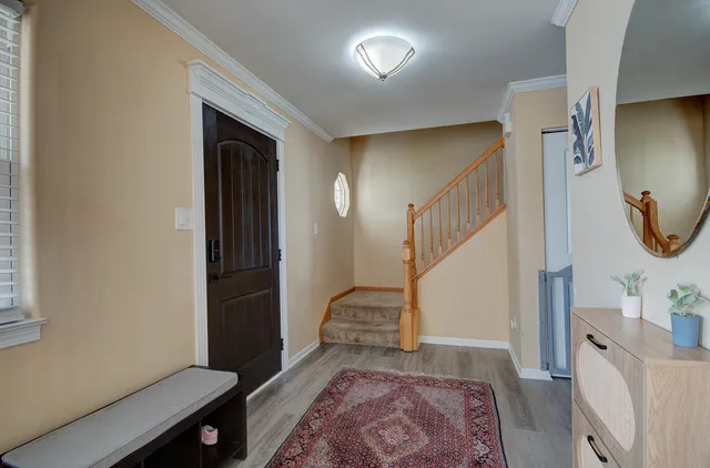 a view of entryway and hall with wooden floor
