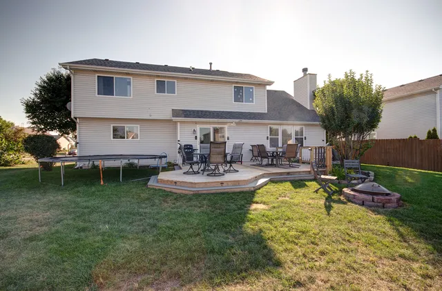 a view of a house with swimming pool yard and a patio