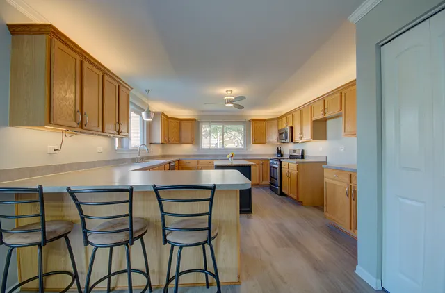 a kitchen with a sink cabinets and wooden floor