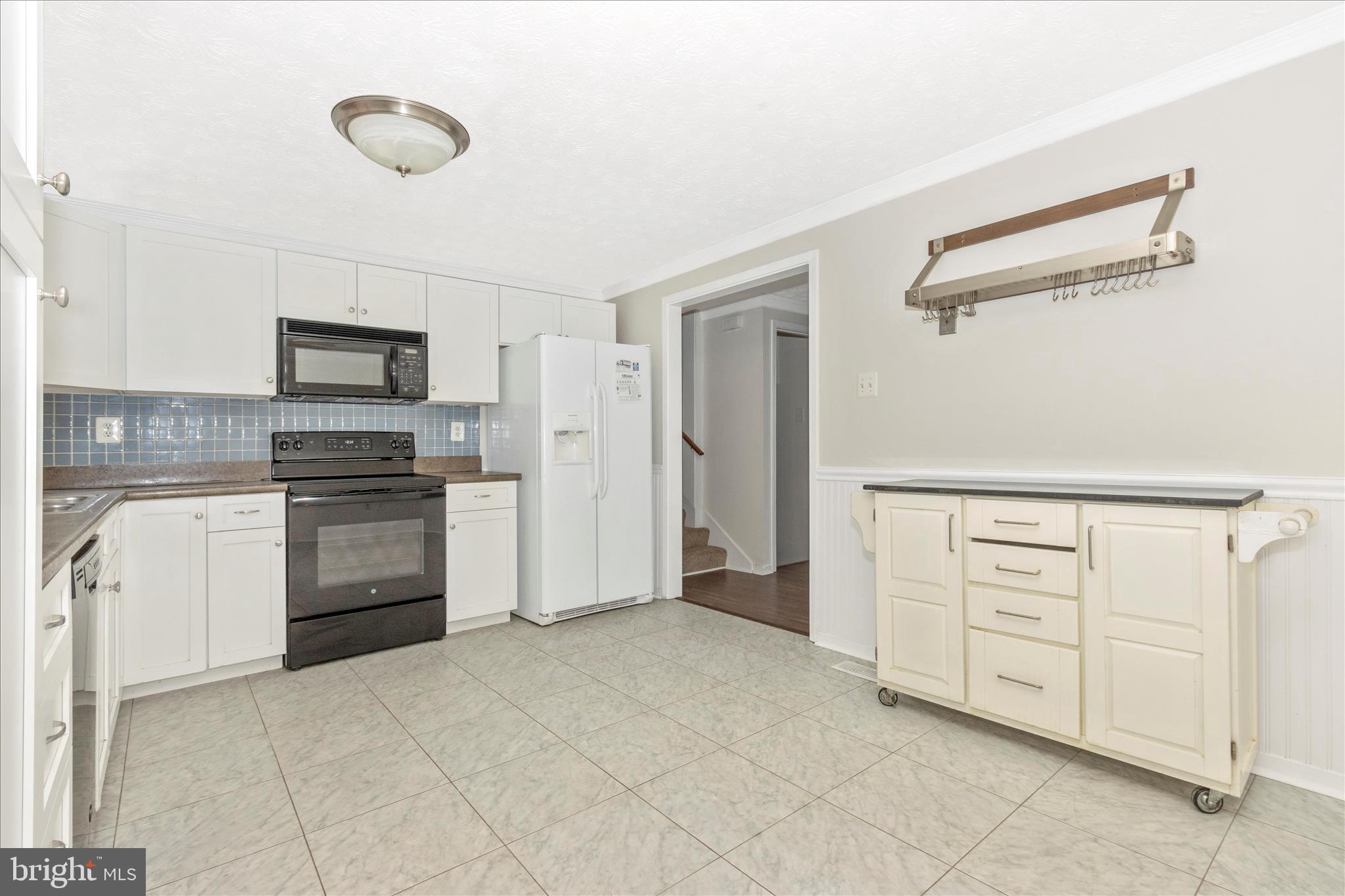 207 Contour Road Mount Airy, MD 21771 - Photo 11 of 52 a kitchen with white cabinets and stainless steel appliances