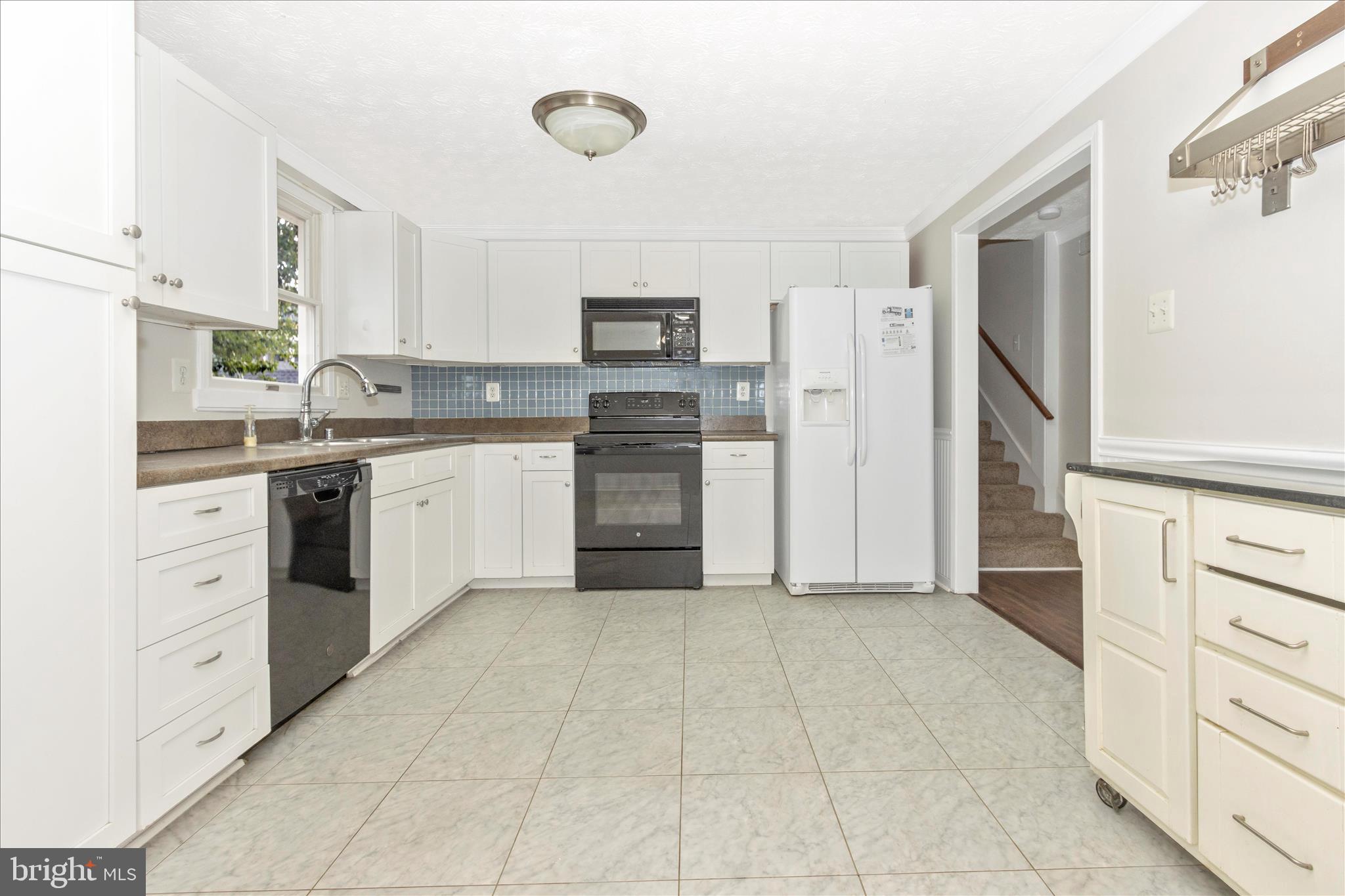 207 Contour Road Mount Airy, MD 21771 - Photo 12 of 52 a kitchen with cabinets and stainless steel appliances