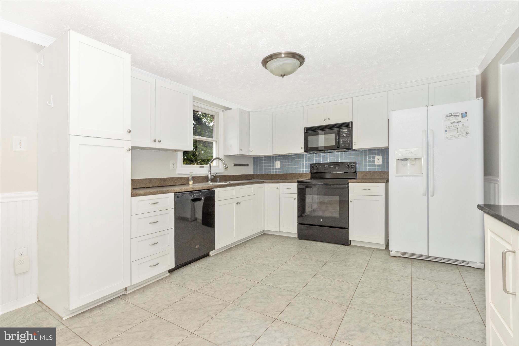 207 Contour Road Mount Airy, MD 21771 - Photo 13 of 52 a kitchen with stainless steel appliances granite countertop white cabinets and refrigerator