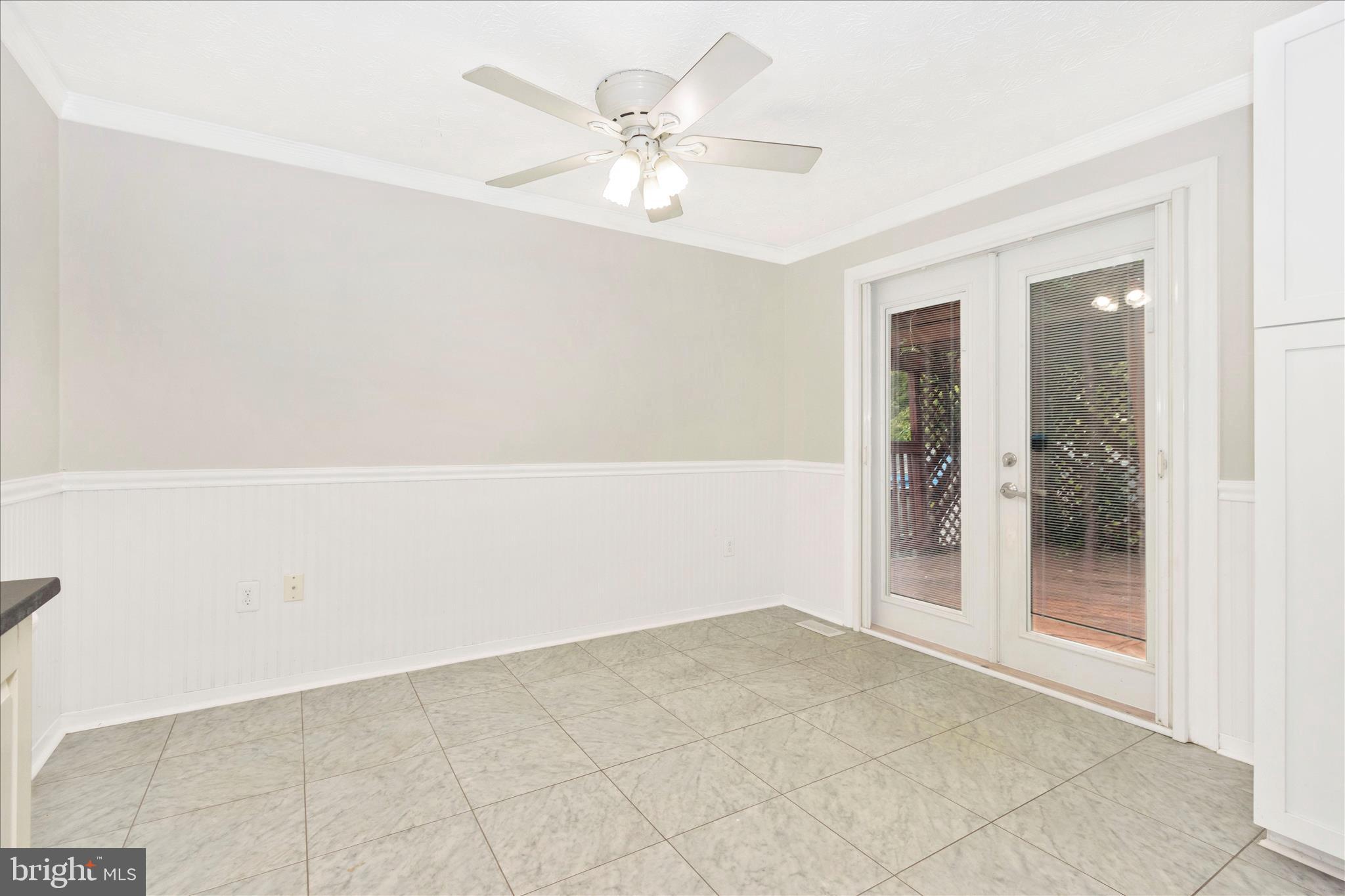 207 Contour Road Mount Airy, MD 21771 - Photo 14 of 52 an empty room with a ceiling fan and glass door