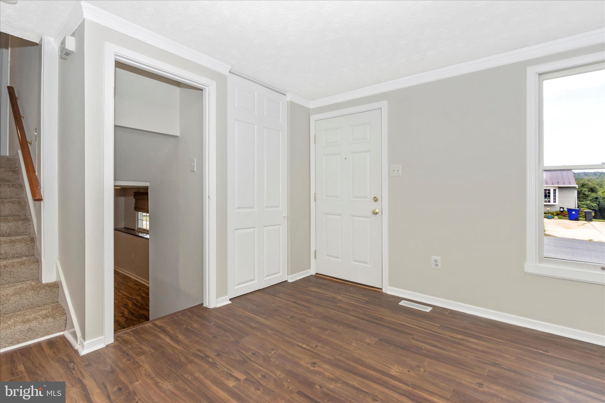 207 Contour Road Mount Airy, MD 21771 - Photo 2 of 52 an empty room with wooden floor and windows