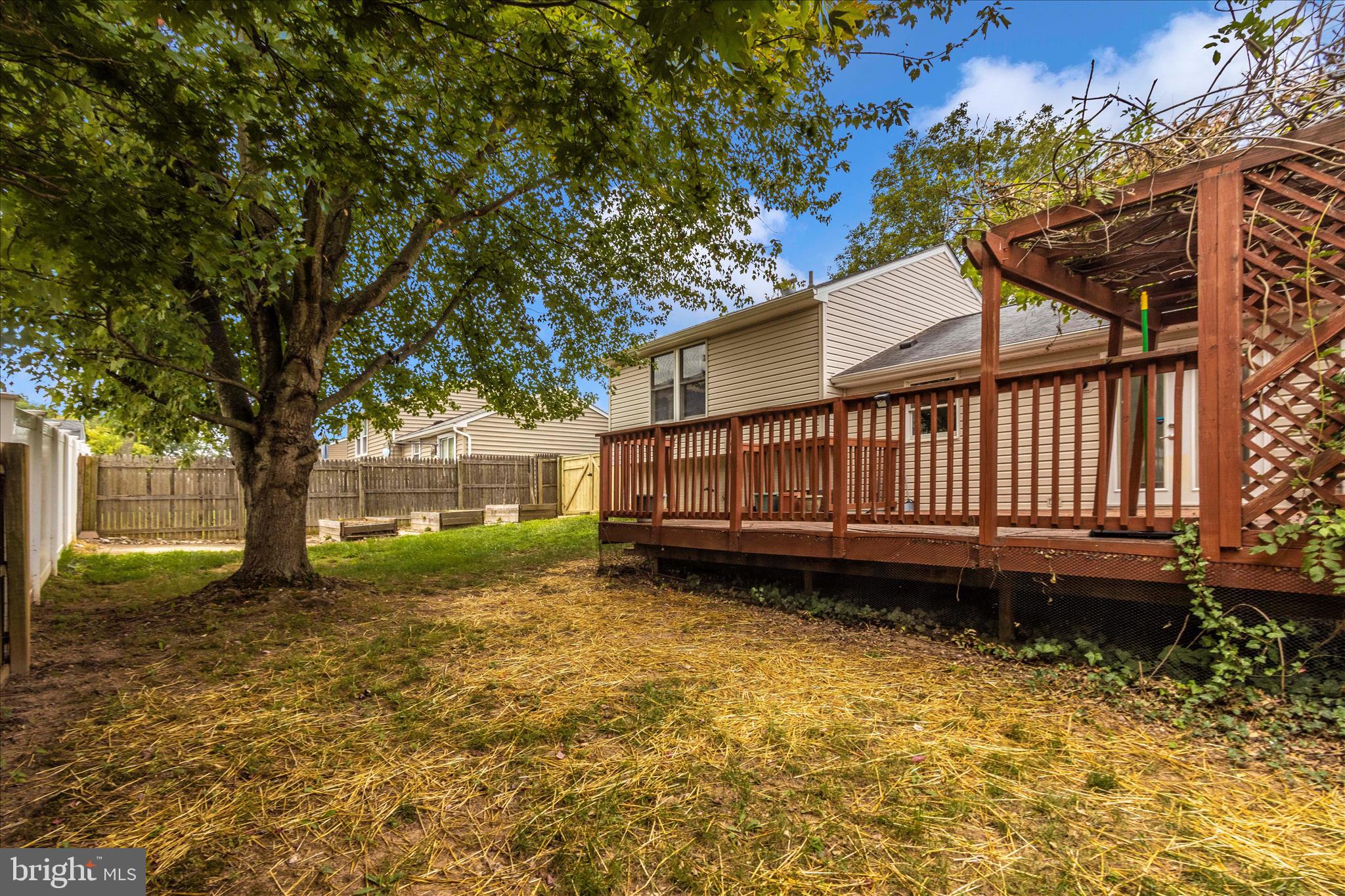 207 Contour Road Mount Airy, MD 21771 - Photo 48 of 52 a view of a backyard with a large tree and wooden fence