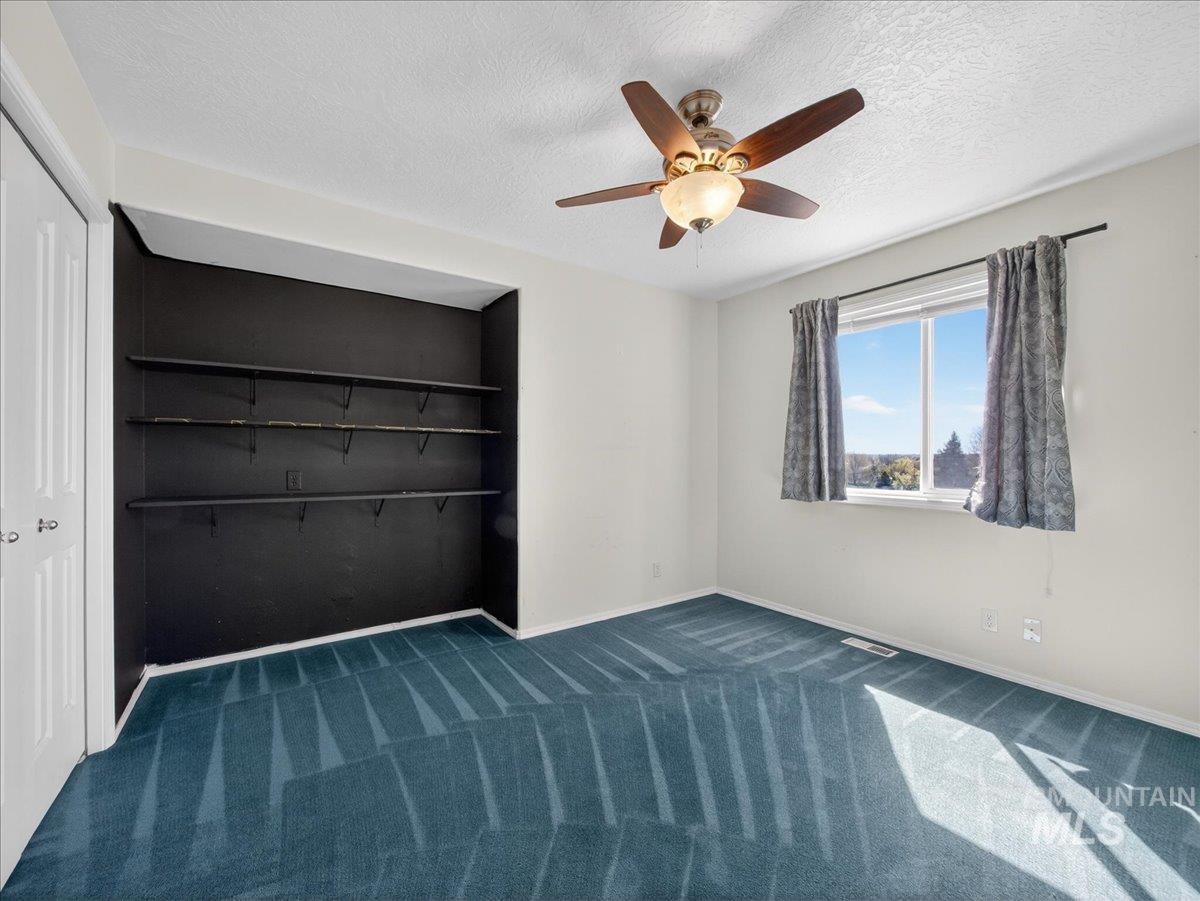 398 Pebble Beach Way Eagle, ID 83616 - Photo 24 of 35 Room featuring built-in shelving, a ceiling fan with integrated lighting, and a window with white casing