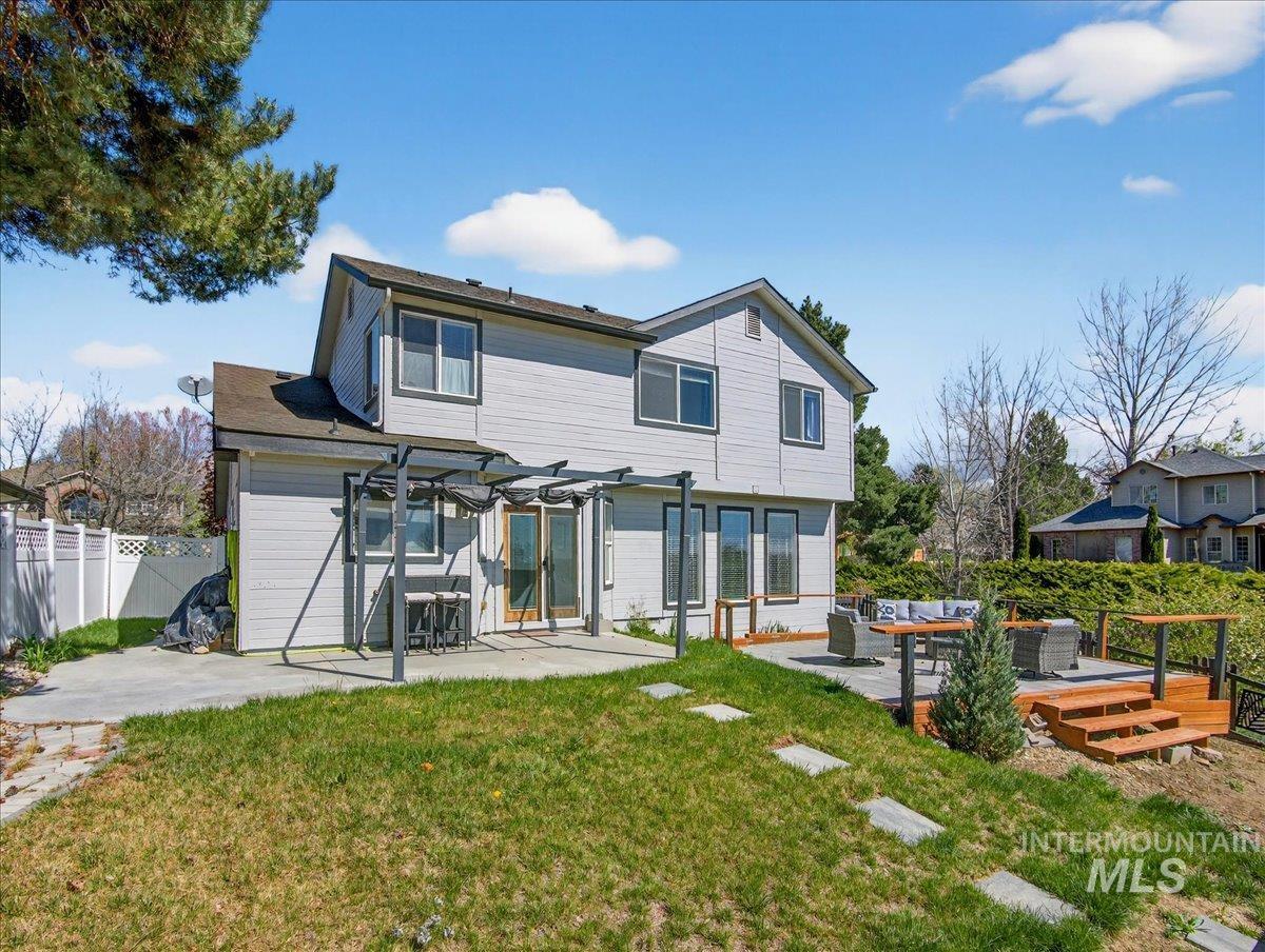 398 Pebble Beach Way Eagle, ID 83616 - Photo 32 of 35 Rear exterior featuring a multi-level composite deck, concrete patio, and sloped lawn with stepping stones