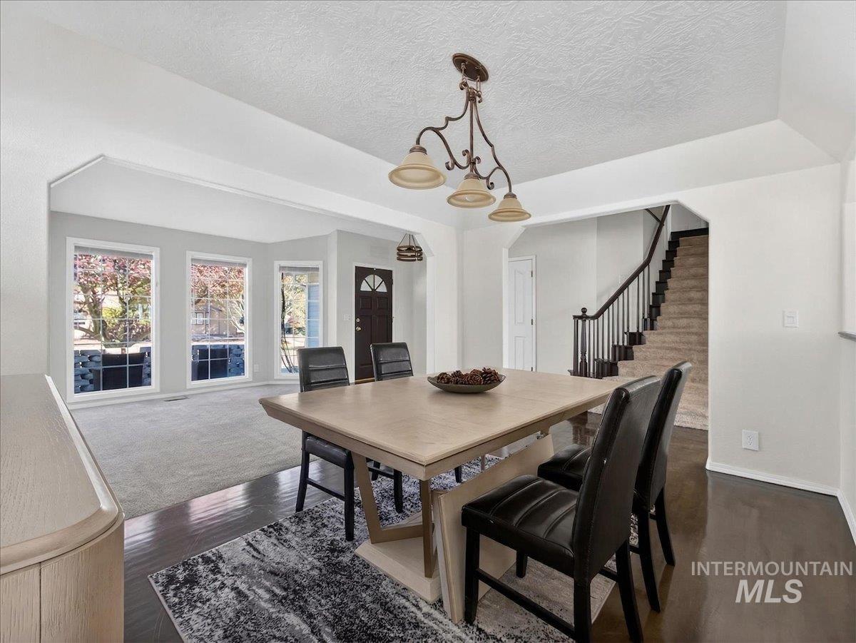 398 Pebble Beach Way Eagle, ID 83616 - Photo 7 of 35 Dining area featuring a contemporary chandelier and wood-finish flooring