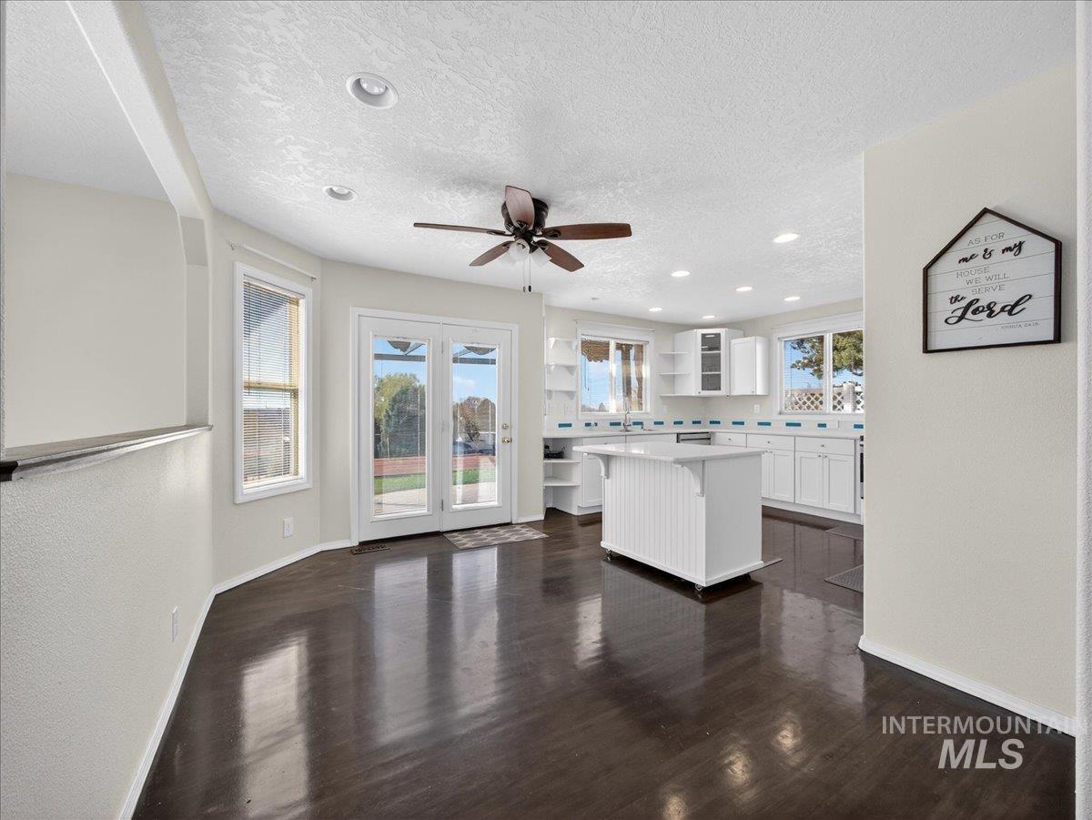 398 Pebble Beach Way Eagle, ID 83616 - Photo 8 of 35 Expansive open-concept room featuring dark wood-finish flooring, a ceiling fan with integrated lighting, and recessed lighting