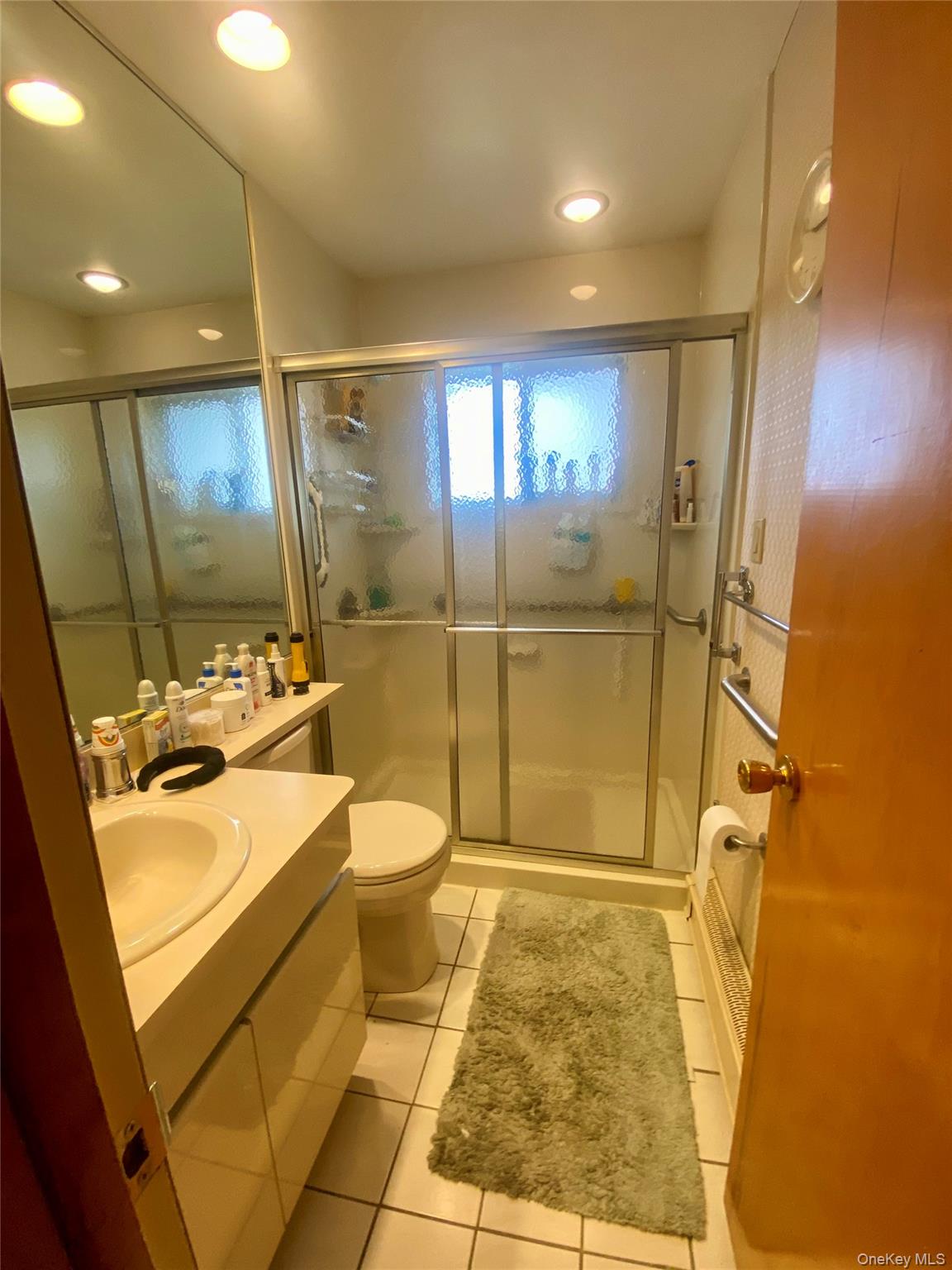 816 Anderson Avenue Franklin Square, NY 11010 - Photo 11 of 11 a bathroom with a sink and mirror with toilet